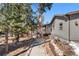 Charming single-story home surrounded by mature trees and a decorative wagon wheel at 2859 Cagle Dr, Larkspur, CO 80118