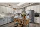 Bright kitchen features stainless steel appliances, subway tile backsplash and a kitchen island with butcher block top at 2859 Cagle Dr, Larkspur, CO 80118