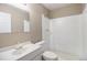 A bright bathroom features a vanity with a granite countertop, a mirror, and a tiled shower at 10792 E Exposition Ave # 154, Aurora, CO 80012