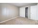 Cozy bedroom with neutral walls, carpeted floors and closet with shelving at 10792 E Exposition Ave # 154, Aurora, CO 80012