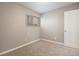 Bedroom features carpeted floor, neutral paint, window and white door at 10792 E Exposition Ave # 154, Aurora, CO 80012
