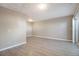 A spacious bedroom with modern vinyl floors, neutral walls, and sliding glass door at 10792 E Exposition Ave # 154, Aurora, CO 80012