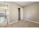 Bedroom with sliding closet door, neutral paint, and carpet at 10792 E Exposition Ave # 154, Aurora, CO 80012