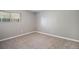 A carpeted bedroom showcases a single window with blinds and neutral walls at 10792 E Exposition Ave # 154, Aurora, CO 80012