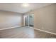 A light-filled bedroom with vinyl floors, neutral walls, and a sliding glass door at 10792 E Exposition Ave # 154, Aurora, CO 80012
