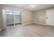 A bedroom with vinyl floors, neutral walls, a sliding glass door and access to a patio at 10792 E Exposition Ave # 154, Aurora, CO 80012