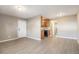 An open-concept living room features new vinyl floors and a view of the adjacent kitchen with wood cabinets at 10792 E Exposition Ave # 154, Aurora, CO 80012