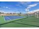 Well-lit outdoor tennis courts with green and blue surfaces, ready for competitive play at 10792 E Exposition Ave # 154, Aurora, CO 80012