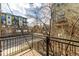 Balcony view overlooking the street below, lined with trees, and showing neighboring buildings at 2501 15Th St # 2C, Denver, CO 80211