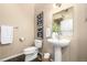 Neutral toned half bathroom featuring a pedestal sink, white fixtures, and tiled floor at 2501 15Th St # 2C, Denver, CO 80211