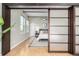 Primary bedroom featuring sliding panel doors to the living room, high ceilings, and natural light at 2501 15Th St # 2C, Denver, CO 80211