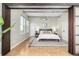 Bedroom featuring sliding panel doors, high ceilings with exposed ductwork, and natural light at 2501 15Th St # 2C, Denver, CO 80211