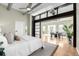 Bright bedroom featuring exposed ductwork, sliding panel doors, and an open floor plan at 2501 15Th St # 2C, Denver, CO 80211