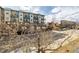 Elevated view of city street with buildings, bare winter trees in foreground at 2501 15Th St # 2C, Denver, CO 80211