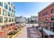 A brick paved walkway leads to the street with buildings on either side at 2501 15Th St # 2C, Denver, CO 80211