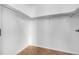 This walk-in closet features a white interior with a cork-style floor and clothes rods for storage at 2501 15Th St # 2C, Denver, CO 80211