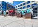 Commercial building featuring a street-level patio area with colorful designs and seating at 2501 15Th St # 2C, Denver, CO 80211