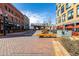 Street-level exterior view showcasing a pedestrian walkway with brick pavers, benches and retail spaces at 2501 15Th St # 2C, Denver, CO 80211