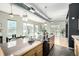 Open concept kitchen with stone countertops, views to dining, living and outdoor balcony at 2501 15Th St # 2C, Denver, CO 80211