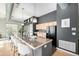Modern kitchen with stainless steel appliances, bar seating, and ample counter space at 2501 15Th St # 2C, Denver, CO 80211