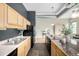 Kitchen features tile floors, stainless steel appliances, granite counters, island, and modern cabinets at 2501 15Th St # 2C, Denver, CO 80211