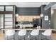 A well-appointed kitchen featuring stone countertops, a breakfast bar, and stainless steel appliances at 2501 15Th St # 2C, Denver, CO 80211
