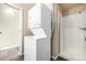 Bathroom featuring a compact stacked washer/dryer unit and a standing shower with white square tiles at 2501 15Th St # 2C, Denver, CO 80211