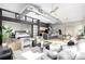Bright, open floor plan with modern decor, kitchen island, and visible bedroom enhance this inviting living space at 2501 15Th St # 2C, Denver, CO 80211