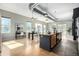 Bright living room features windows, hardwood floors, and dining area with plenty of sunlight at 2501 15Th St # 2C, Denver, CO 80211