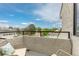 Balcony featuring comfortable seating and a scenic neighborhood view with a community pool at 1820 Newland Ct # 310, Lakewood, CO 80214
