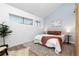 Cozy bedroom with a neutral color palette, featuring a comfortable queen bed and bright natural light at 1820 Newland Ct # 310, Lakewood, CO 80214