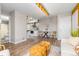 Open-concept living space with hardwood floors blending seamlessly into the adjacent kitchen at 1820 Newland Ct # 310, Lakewood, CO 80214