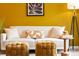 Comfortable living room featuring a white sofa, gold ottoman, and trendy decor at 1820 Newland Ct # 310, Lakewood, CO 80214