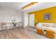 Spacious living room boasts hardwood floors, a table and chairs, and a cozy white sofa at 1820 Newland Ct # 310, Lakewood, CO 80214