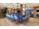 Custom bar featuring seating for ten, custom lighting and adjacent glass-encased wine storage at 77 Comstock Pl, Castle Rock, CO 80108