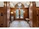 Grand foyer with wood paneling, elegant doors, decorative rug, and stylish light fixture at 77 Comstock Pl, Castle Rock, CO 80108