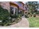 Beautifully landscaped front yard with stone pathway leading to a grand brick and stone home at 77 Comstock Pl, Castle Rock, CO 80108