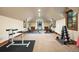 Spacious home gym equipped with various exercise machines, free weights, and ample natural light at 77 Comstock Pl, Castle Rock, CO 80108