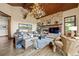 Inviting living room with stone fireplace, antler chandelier, and comfortable seating at 77 Comstock Pl, Castle Rock, CO 80108