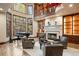 Sophisticated living room featuring a fireplace, grand piano, and oversized windows at 77 Comstock Pl, Castle Rock, CO 80108