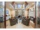 Elegant living room with fireplace, high ceilings, large windows, and comfortable seating arrangement at 77 Comstock Pl, Castle Rock, CO 80108
