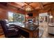 Executive office with a fireplace, large desk, and exterior views of the property at 77 Comstock Pl, Castle Rock, CO 80108