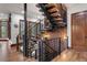 Modern staircase with wood and metal accents; open-concept design with natural light at 77 Comstock Pl, Castle Rock, CO 80108