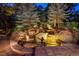 Serene illuminated water feature with cascading waterfalls and lush landscaping, perfect for relaxation at 77 Comstock Pl, Castle Rock, CO 80108