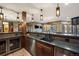 Modern bar featuring wood cabinets, stainless appliances, granite countertops, and bar seating at 77 Comstock Pl, Castle Rock, CO 80108