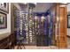 Temperature-controlled wine cellar with custom shelving and glass doors at 77 Comstock Pl, Castle Rock, CO 80108