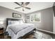 Comfortable bedroom with a large window, ceiling fan, and ample natural light at 3134 S Fairplay St, Aurora, CO 80014