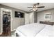 Bedroom boasts a TV, ceiling fan, walk-in closet, and wood-look flooring at 3134 S Fairplay St, Aurora, CO 80014
