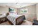 Bedroom featuring a wood bed frame, side table, and a bright window at 3134 S Fairplay St, Aurora, CO 80014