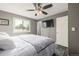 Cozy bedroom with ceiling fan, TV, closet, and large window for natural light at 3134 S Fairplay St, Aurora, CO 80014